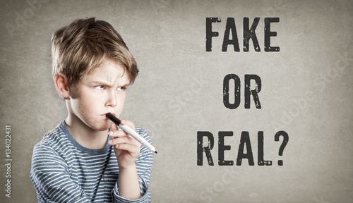 Fake or real, Boy on grunge background photo