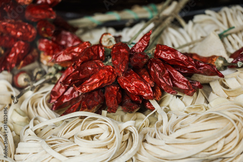 Fresh italian tagliatelle pasta and dried chilie peppers.