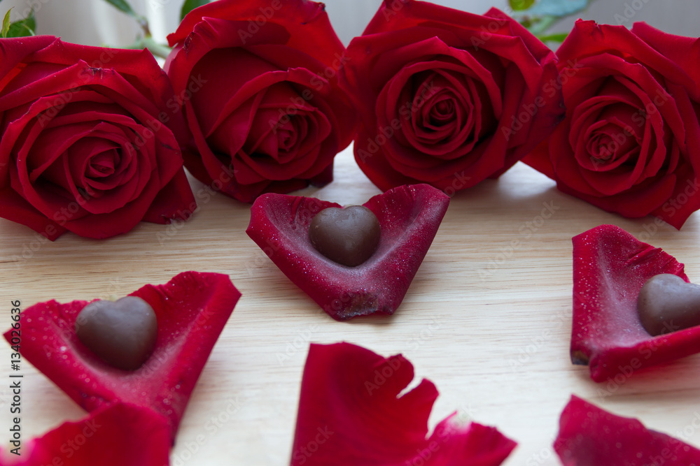 red roses with chocolate in petals red roses with chocolate in petals