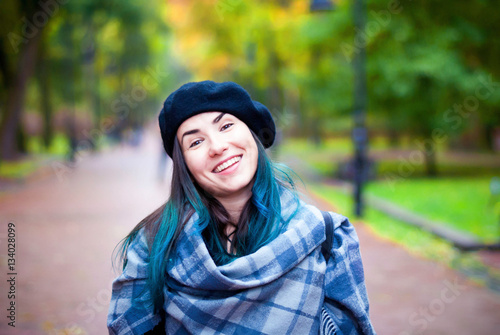 Happy beautiful girl in black beret. Woman with blue hair.