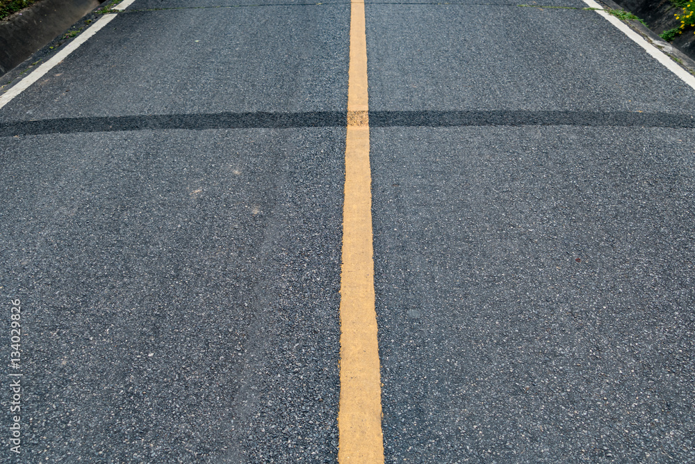 Fototapeta premium Asphalt road with yellow line