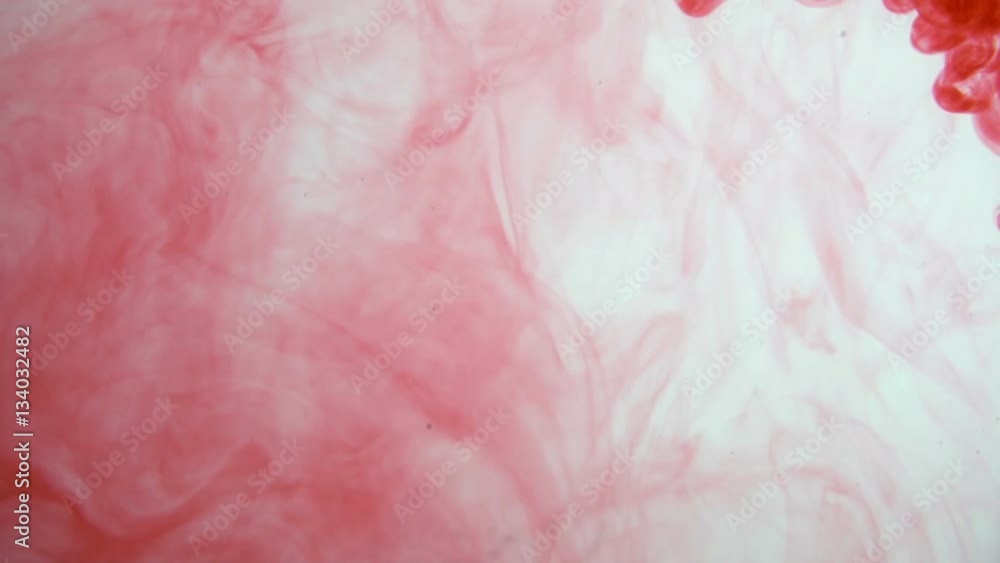 red ink poured into clear water red ink poured into clear water