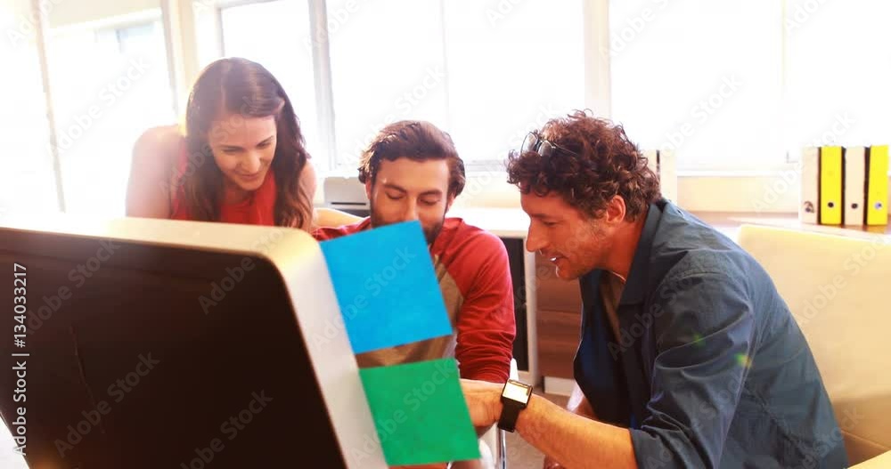 Group of graphic designers interacting while using digital tablet Group of graphic designers interacting while using digital tablet