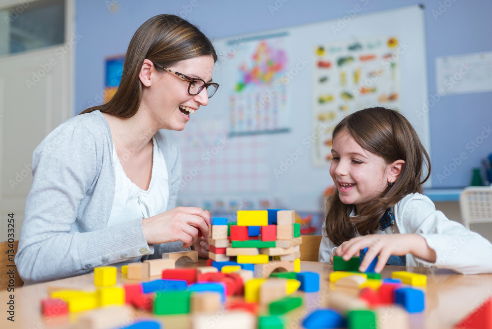 Mother and Daughter Playing Together with Colorful Toy Building Blocks Mother and Daughter Playing Together with Colorful Toy Building Blocks