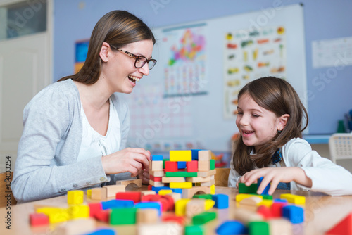 Mother and Daughter Playing Together with Colorful Toy Building Blocks