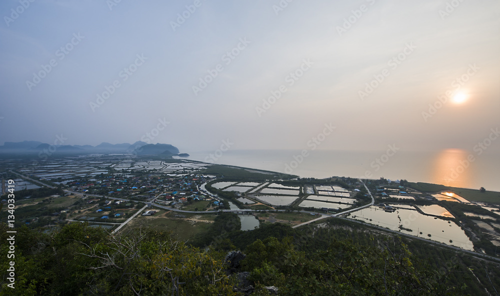 Blurry image, Aerial view from top mountain, the fisherman village on the shore in early morning at the gulf of Thailand. 