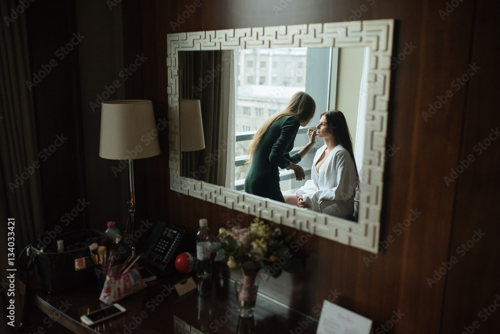 Fototapeta premium Wedding makeup artist making a make up for bride.