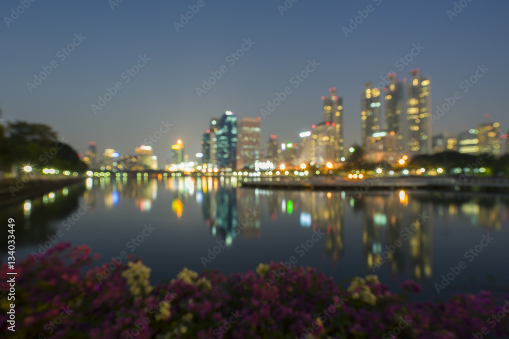 Blurry image of Bangkok business district at Sukhumvit road, the buildings towers and reflection.