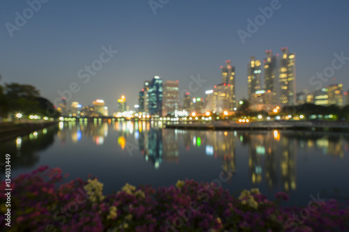 Blurry image of Bangkok business district at Sukhumvit road  the buildings towers and reflection.