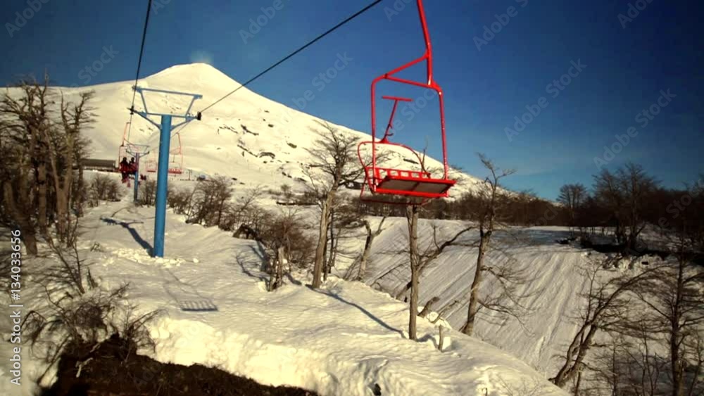View from the ski lift, skiers and snowboards using the ski lift to go to the top of the resort. Ski Pucon is a ski field situated close to the Volcan Villarrica. View from the ski lift, skiers and snowboards using the ski lift to go to the top of the resort. Ski Pucon is a ski field situated close to the Volcan Villarrica.
