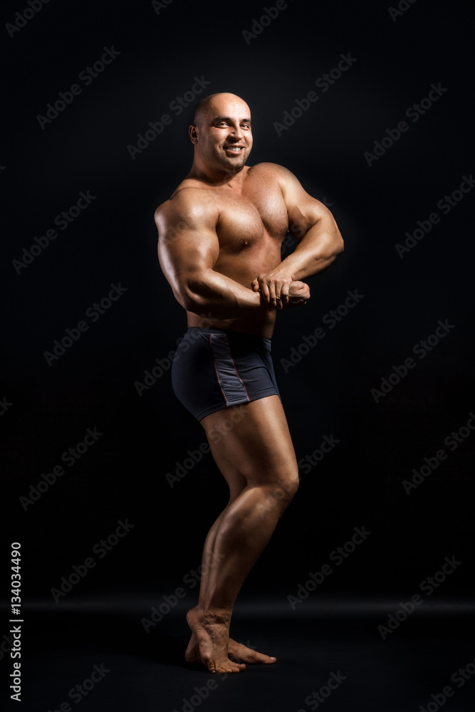 Obraz premium Bodybuilder Topless Over Black Background