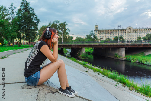 Asian girl listening to music with headphones photo