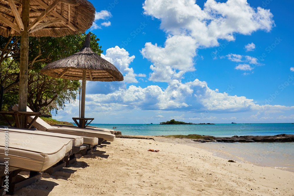 White sand beach with lounge chairs and umbrellas in Mauritius I