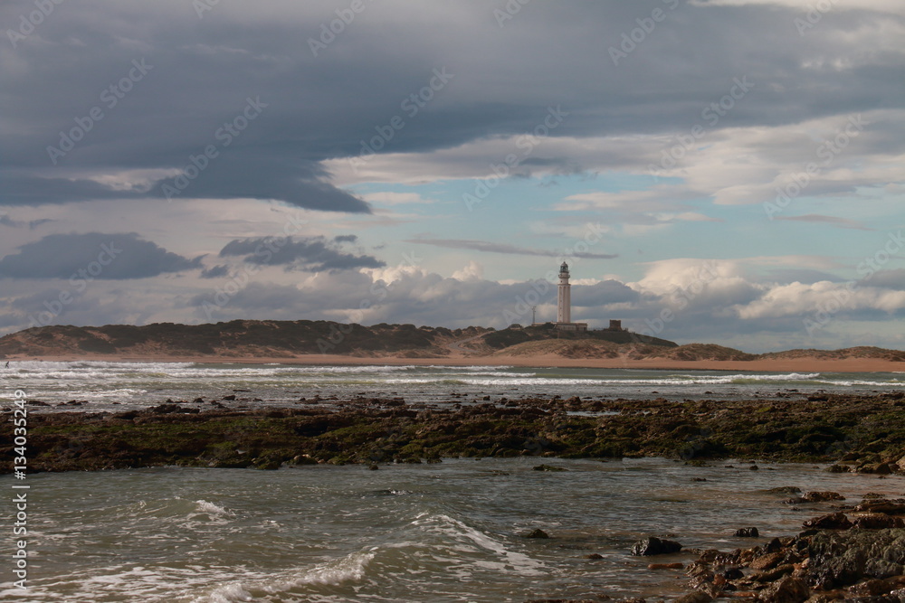 The lighthouse of Cape Trafalgar on a cloudy day, on the coasts of southern Spain