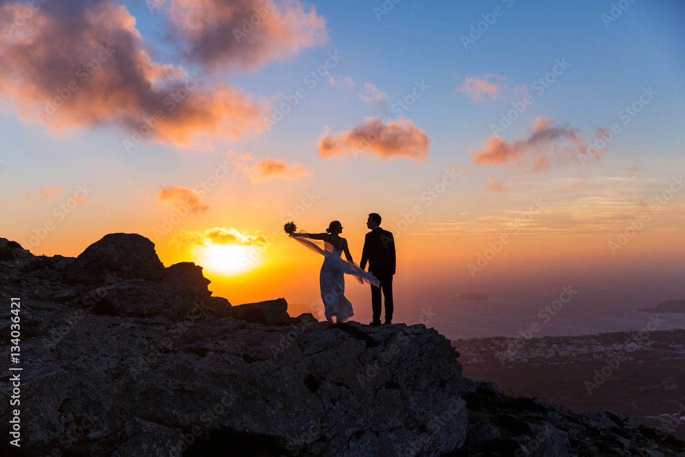 Silhouette of bride and groom on  sea sunset