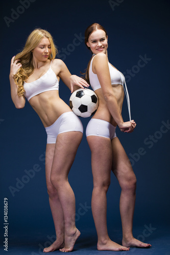 Two Young beautiful women in white fitness clothing