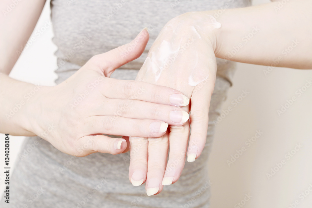 Woman rubbing cream in hands Woman rubbing cream in hands