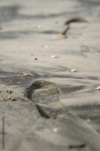Footprints on dark sand