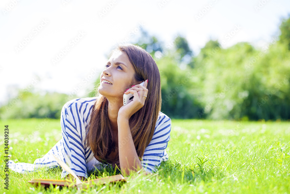 Young woman talking on a cell phone Young woman talking on a cell phone