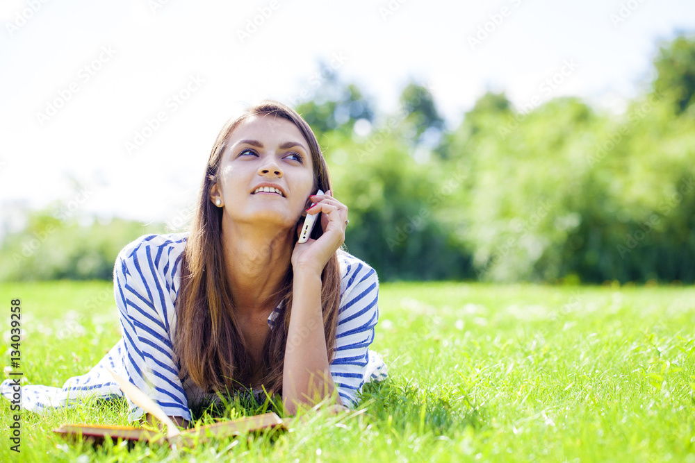 Young woman talking on a cell phone Young woman talking on a cell phone