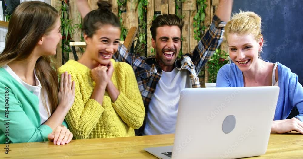 Group of friends using laptop while having coffee Group of friends using laptop while having coffee
