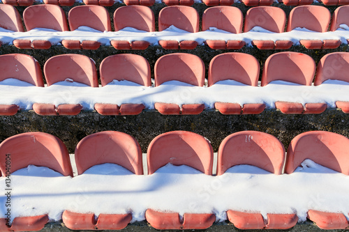 Empty snowy stadium seats