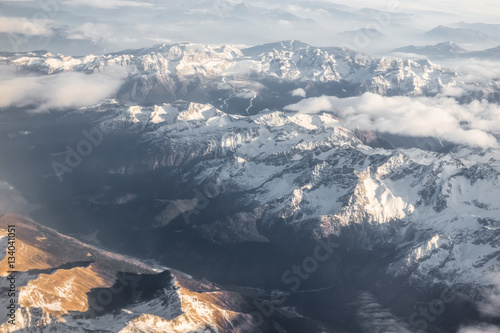 Aerial view of snowy mountains and clouds