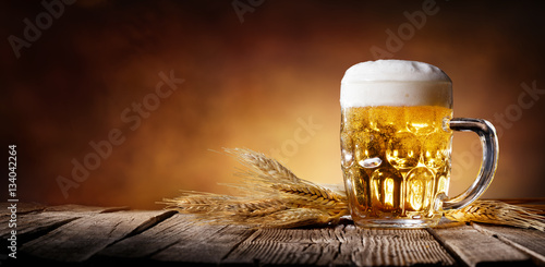 Beer With Wheat On Wooden Table  