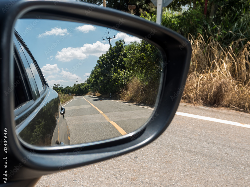 Car side mirror reflex the road. Car side mirror reflex the road.