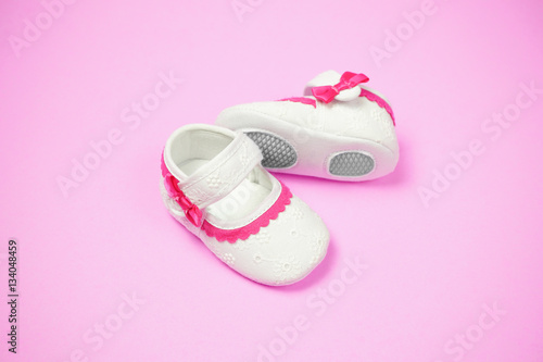Children's shoes pink background.