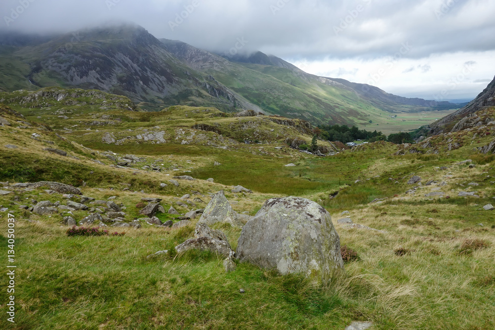Walking path in Snowdonia National Park, North Wales, United Kingdom; view of the mountains in a cold foggy weather, selective focus Walking path in Snowdonia National Park, North Wales, United Kingdom; view of the mountains in a cold foggy weather, selective focus