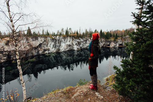 Pretty nice girl enjoy beautiful lake view from the hilltopl and good weather in Karelia. Around the rocks. photo