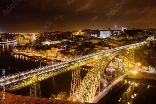 Dom Luis I bridge over Douro river illuminated at night, Porto, Portugal