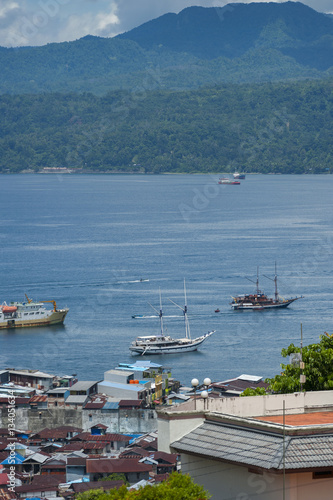 Ambon City Harbor. A phinisi schooner sits anchored in the Ambon city harbor of Ambon Island, Indonesia.