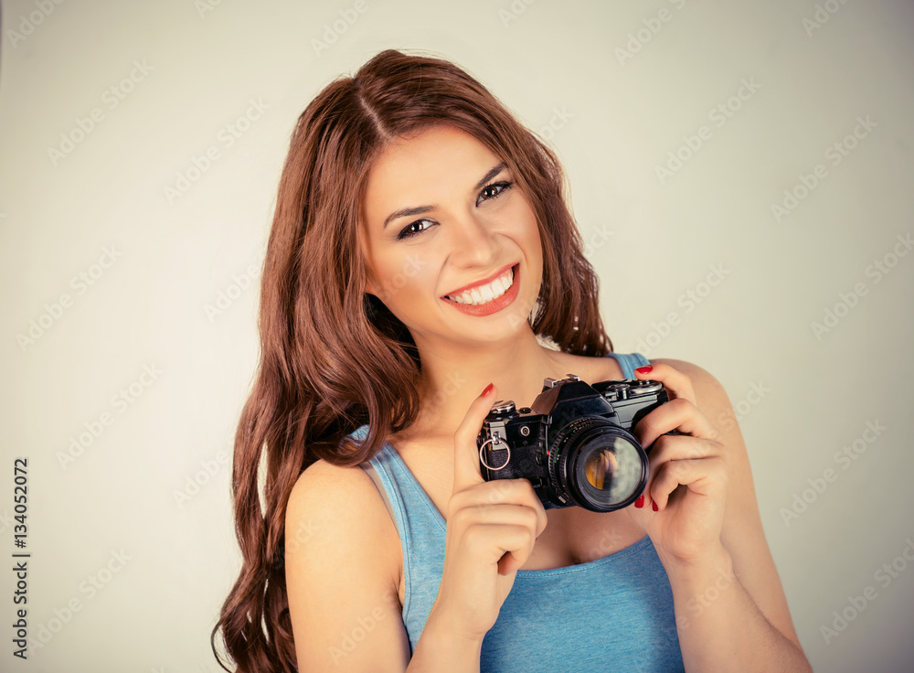 Photographer. Woman smiling taking pictures holding dslr camera