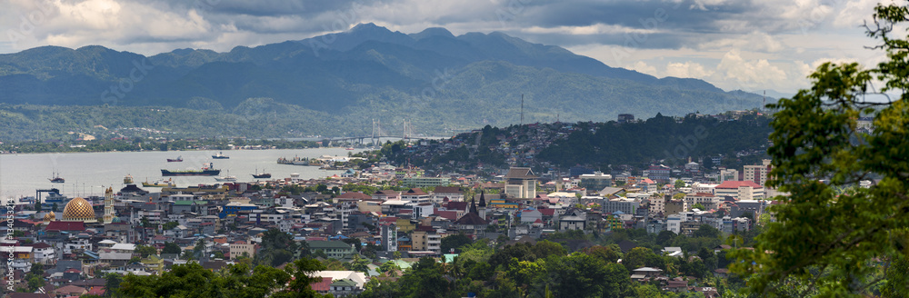Ambon City, Indonesia. Ambon City on Ambon Island boasts excellent transport connections and facilities and make it a gateway to Maluku, and its colonial forts, green hills and pleasant beaches.