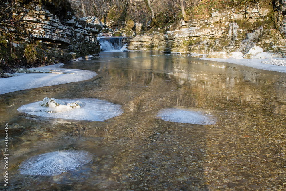 Winter Water Landscape with Ice Crystal on river rocks