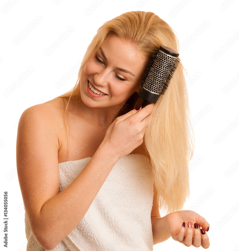 Beautiful blonde woman brushing her hair as a sign og hair care Beautiful blonde woman brushing her hair as a sign og hair care