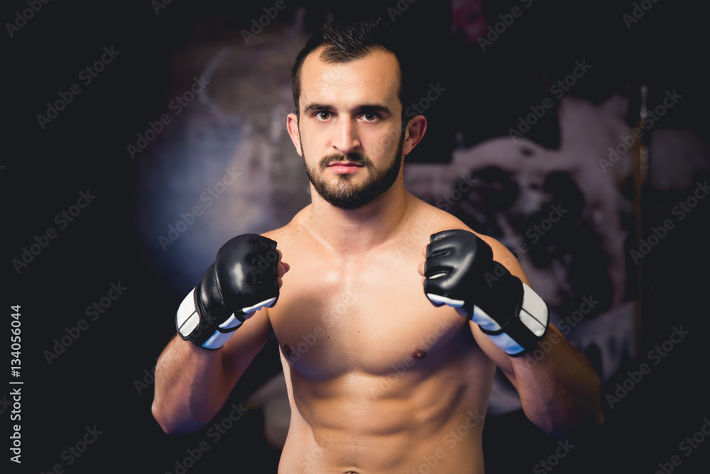 Mixed martial art fighter standing in guard facing camera in close up shot