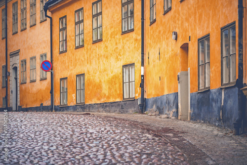 Old parts of Stockhom with cobblestones and orange old facades photo