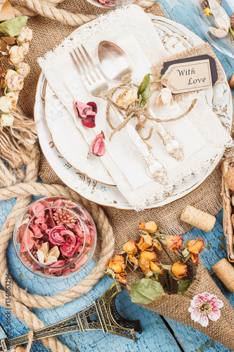 Tableware and silverware with different decorations on the table