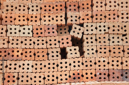 Lined outdoor stacking bricks on background.