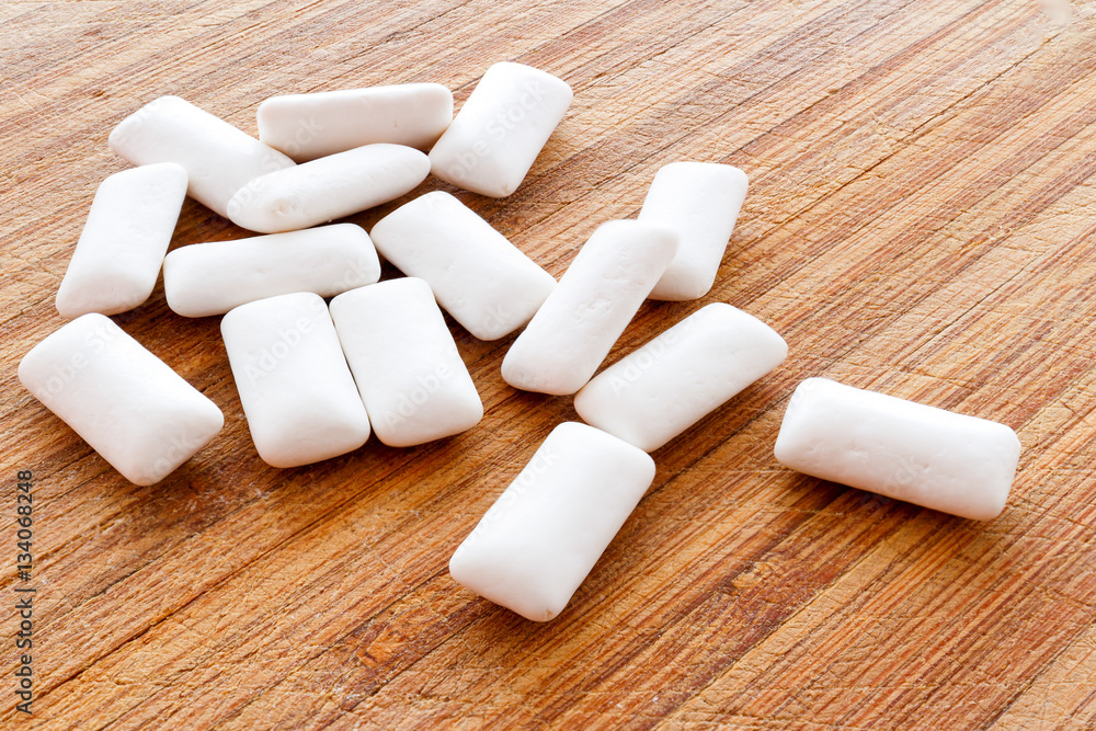 Chewing gum pieces on a wooden background Chewing gum pieces on a wooden background