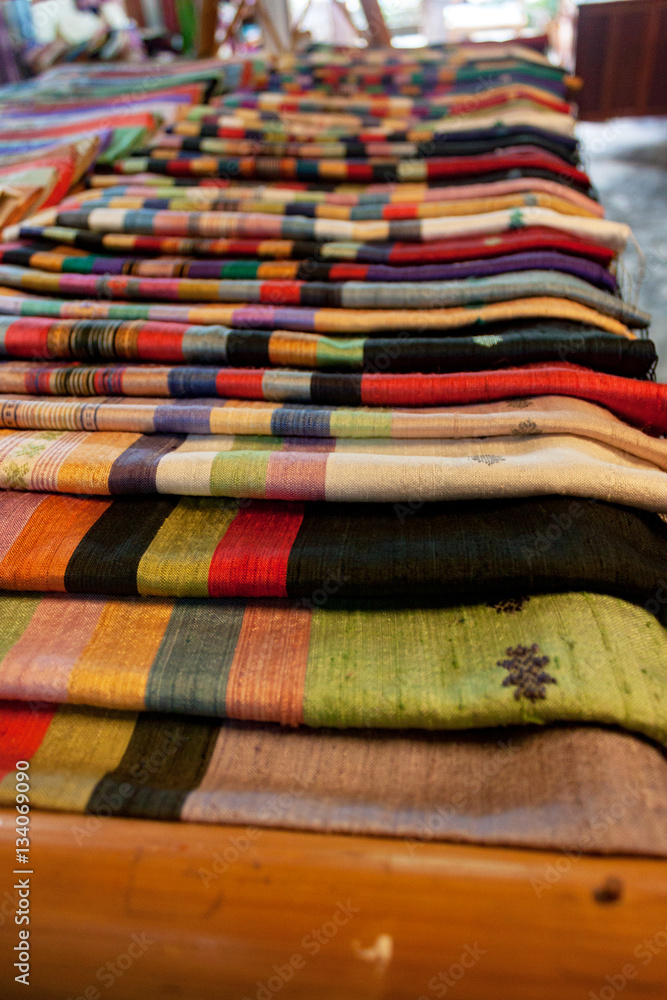 Closeup of fiinished silk on display at a rural traditional silk manufacturer in Luang Prabang, Laos. Closeup of fiinished silk on display at a rural traditional silk manufacturer in Luang Prabang, Laos.