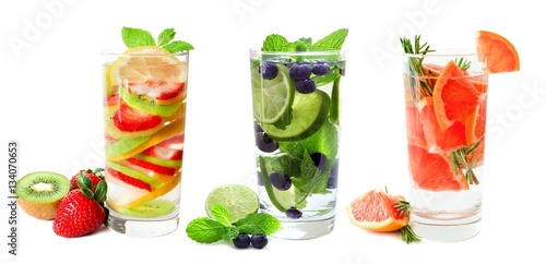 Three types of fruit infused water in glasses isolated on a white background