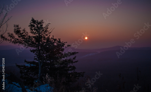 Sunrise in the mountains in winter with long cedar
