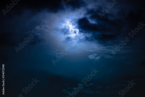 Canvas Print Nighttime sky with clouds and bright full moon with shiny.