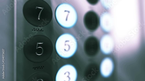 Elevator Button Panel Close up with Floors lighting up on an ambient corporate setting photo