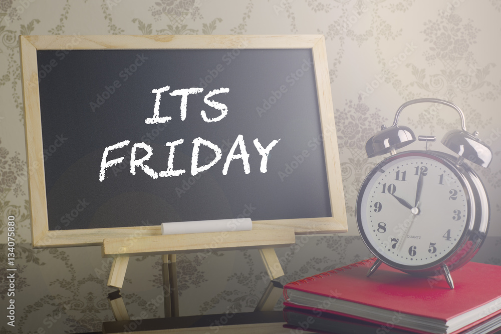 Its Friday on blackboard with flare and clock. Its Friday on blackboard with flare and clock.