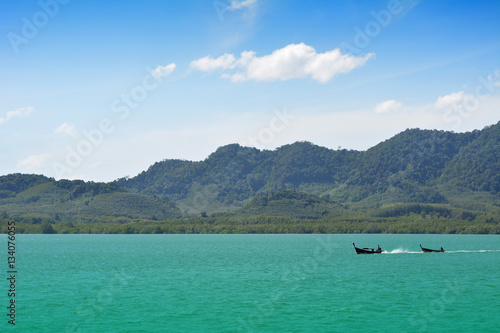 Fototapeta Naklejka Na Ścianę i Meble -  Long tail boat and Green Island with name Coconut Island at Phuket in Thailand. Travel around Asia theme background